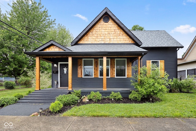 117 N Market St, Thorntown, IN 46071 - view of front facade with covered porch, a shingled roof, and a front lawn