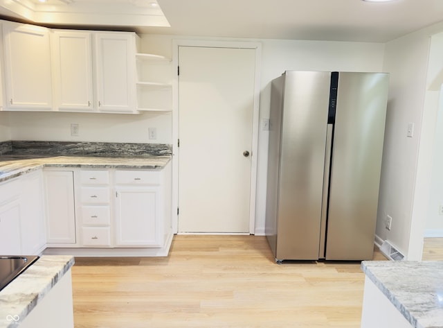 5130 Navajo Ct, Columbus, IN 47203 - kitchen with freestanding refrigerator, white cabinets, light wood-style floors, and open shelves