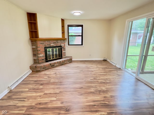 5130 Navajo Ct, Columbus, IN 47203 - unfurnished living room featuring a baseboard heating unit, wood finished floors, plenty of natural light, and a fireplace