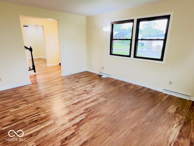 5130 Navajo Ct, Columbus, IN 47203 - empty room with light wood-type flooring, baseboards, and baseboard heating