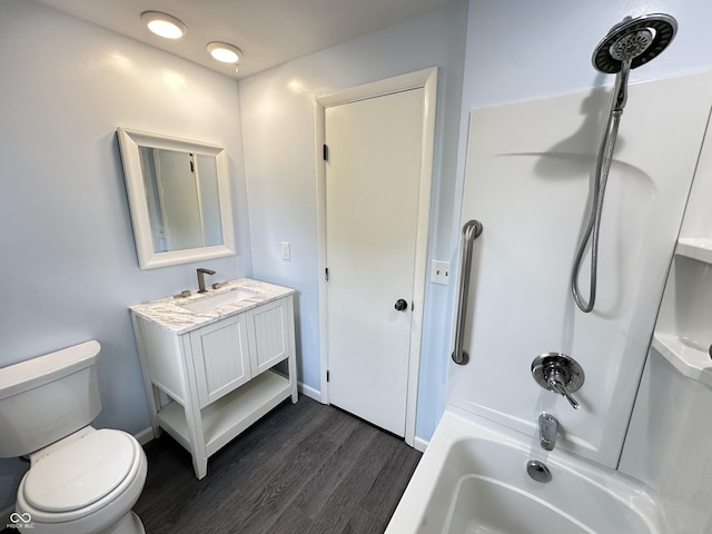 5130 Navajo Ct, Columbus, IN 47203 - bathroom with toilet, wood finished floors, vanity, bathing tub / shower combination, and baseboards