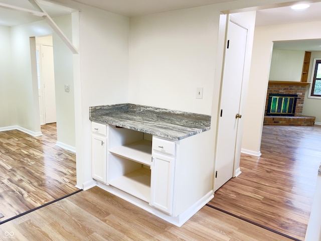 5130 Navajo Ct, Columbus, IN 47203 - kitchen with open shelves, light wood-type flooring, white cabinetry, and baseboards