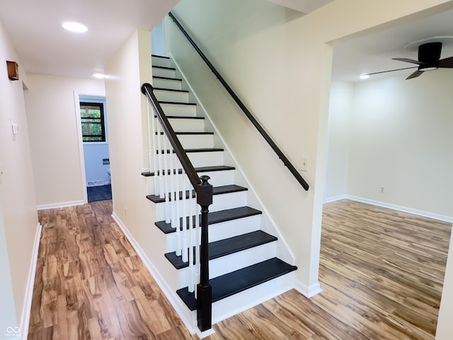 5130 Navajo Ct, Columbus, IN 47203 - stairway with wood finished floors, a ceiling fan, baseboards, and recessed lighting