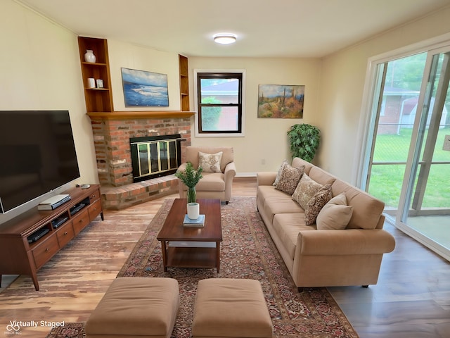 5130 Navajo Ct, Columbus, IN 47203 - living room with wood finished floors, built in features, and a fireplace