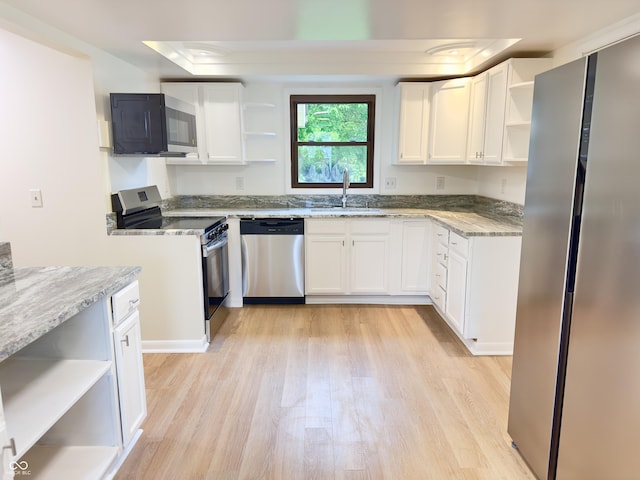 5130 Navajo Ct, Columbus, IN 47203 - kitchen featuring open shelves, appliances with stainless steel finishes, a sink, light wood-style floors, and light stone countertops