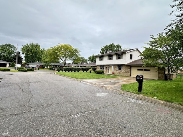 5130 Navajo Ct, Columbus, IN 47203 - view of front of home with brick siding, driveway, a front yard, and an attached garage