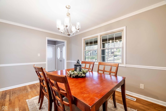 1920 E Wexley Rd, Bloomington, IN 47401 - dining area with a chandelier, ornamental molding, and light wood-style floors