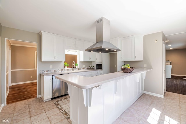 1920 E Wexley Rd, Bloomington, IN 47401 - kitchen with island range hood, dishwasher, light countertops, white cabinetry, and recessed lighting