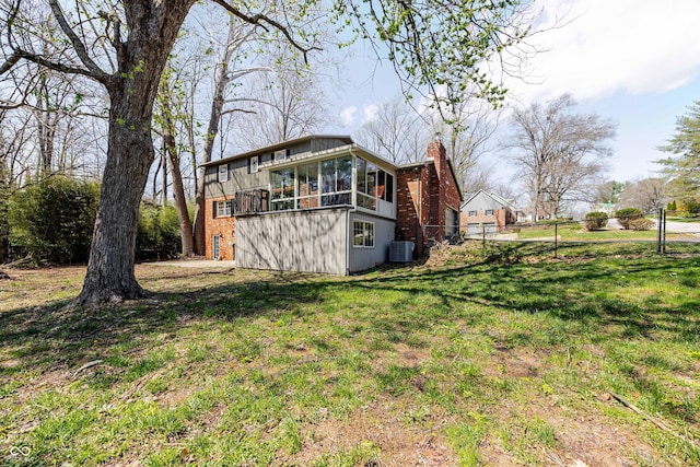 1920 E Wexley Rd, Bloomington, IN 47401 - view of property exterior featuring a sunroom, brick siding, and a chimney