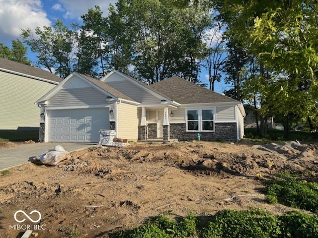 3805 Windstar Way, Columbus, IN 47203 - craftsman inspired home featuring an attached garage, stone siding, driveway, and covered porch