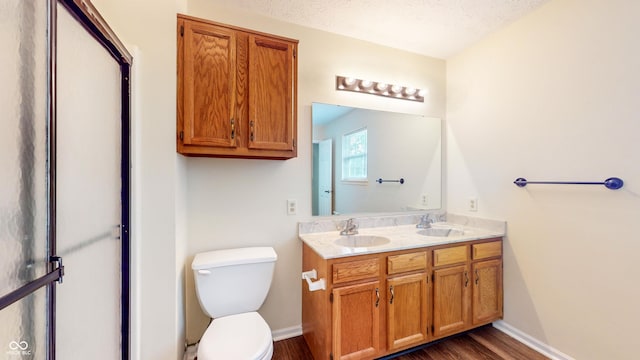 3916 Jekyll Ct, Indianapolis, IN 46237 - bathroom featuring double vanity, wood finished floors, toilet, and baseboards