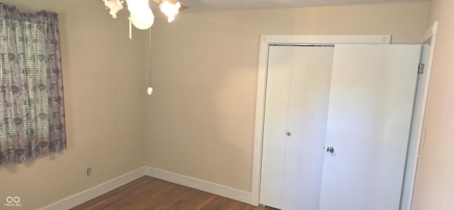3107 N 100 W, Shelbyville, IN 46176 - unfurnished bedroom with dark wood-style flooring, baseboards, and a closet