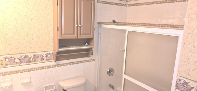 3107 N 100 W, Shelbyville, IN 46176 - full bath with wallpapered walls, bathtub / shower combination, toilet, a wainscoted wall, and tile walls