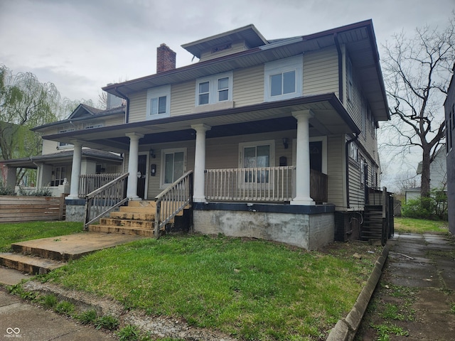 2707-2709 N College Ave, Indianapolis, IN 46205 - traditional style home featuring a chimney, a front lawn, and a porch