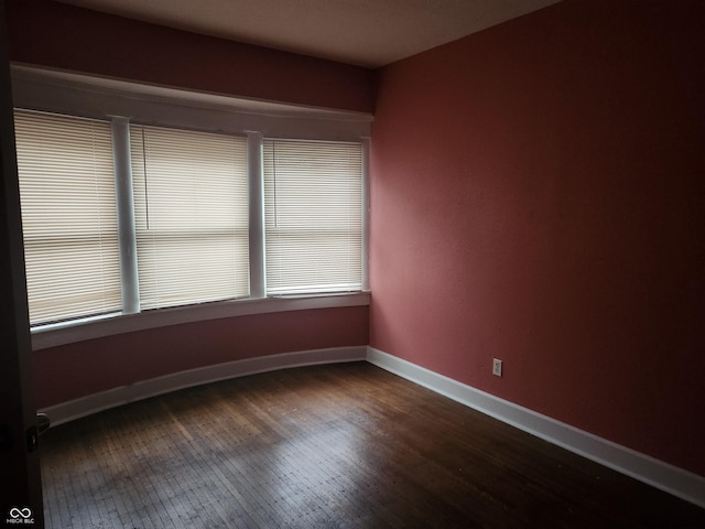 2707-2709 N College Ave, Indianapolis, IN 46205 - unfurnished room featuring dark wood finished floors, healthy amount of natural light, and baseboards