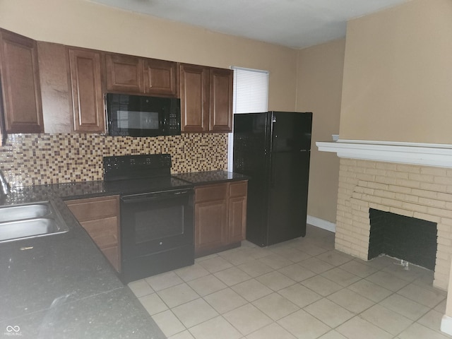2707-2709 N College Ave, Indianapolis, IN 46205 - kitchen featuring black appliances, a sink, tasteful backsplash, dark countertops, and a fireplace