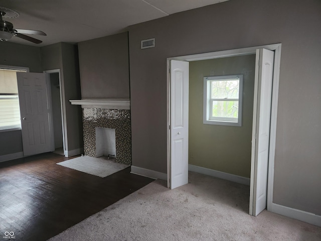 2707-2709 N College Ave, Indianapolis, IN 46205 - unfurnished living room featuring a ceiling fan, baseboards, and a tile fireplace