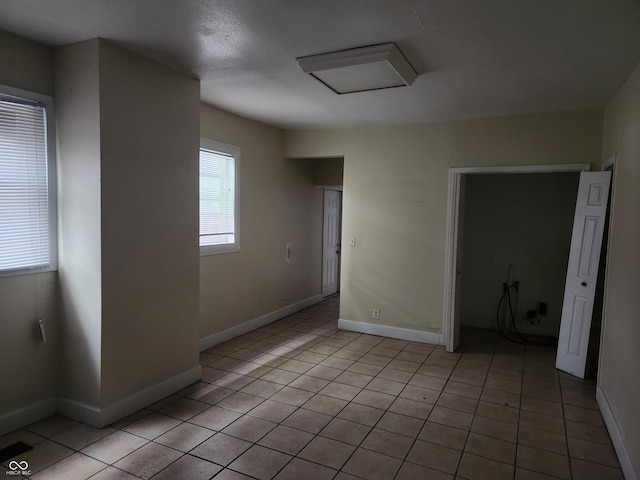 2707-2709 N College Ave, Indianapolis, IN 46205 - spare room with light tile patterned flooring and baseboards