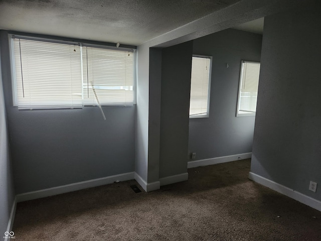 2707-2709 N College Ave, Indianapolis, IN 46205 - carpeted spare room with healthy amount of natural light, a textured ceiling, and baseboards