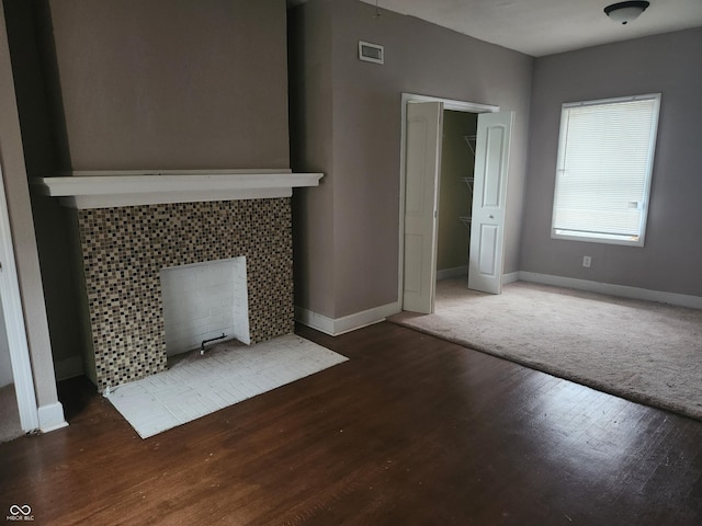 2707-2709 N College Ave, Indianapolis, IN 46205 - unfurnished living room with baseboards, wood finished floors, and a tiled fireplace