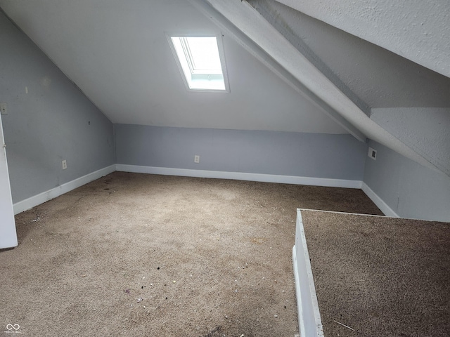 2707-2709 N College Ave, Indianapolis, IN 46205 - bonus room featuring vaulted ceiling, carpet floors, baseboards, and a skylight