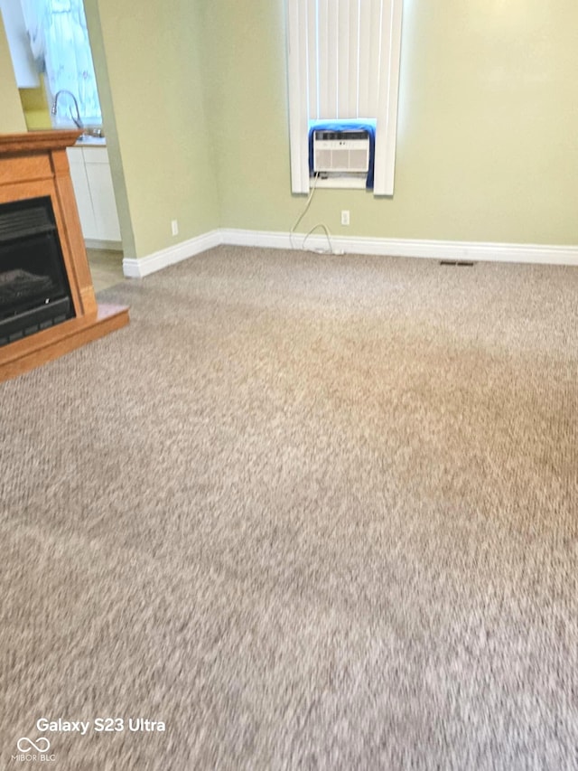 208 E Madison St E, Alexandria, IN 46001 - unfurnished living room with carpet floors, baseboards, a fireplace, and cooling unit