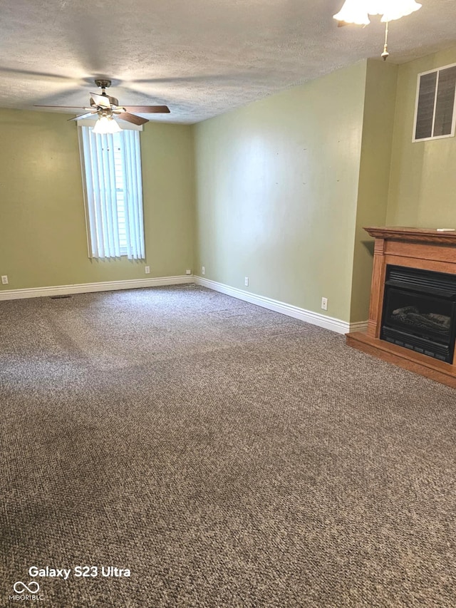 208 E Madison St E, Alexandria, IN 46001 - unfurnished living room with a textured ceiling, baseboards, a ceiling fan, carpet flooring, and a fireplace