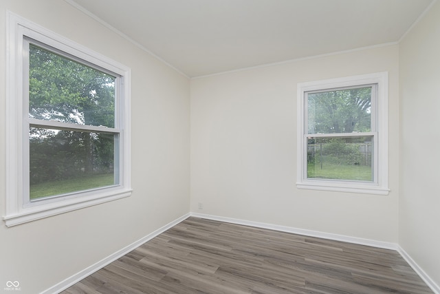 625 E 106th St, Carmel, IN 46280 - empty room with wood finished floors, crown molding, and baseboards