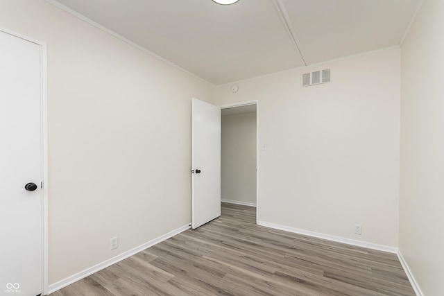 625 E 106th St, Carmel, IN 46280 - unfurnished room with light wood-style floors, baseboards, attic access, and ornamental molding