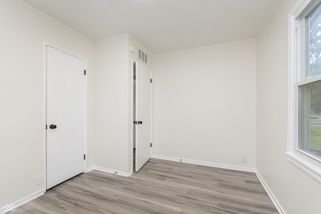 625 E 106th St, Carmel, IN 46280 - unfurnished bedroom featuring light wood-style flooring, crown molding, multiple windows, and baseboards