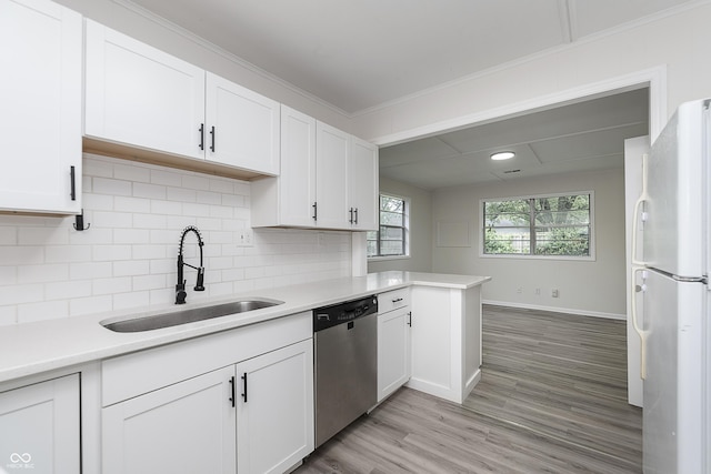 625 E 106th St, Carmel, IN 46280 - kitchen featuring freestanding refrigerator, dishwasher, a sink, light countertops, and white cabinetry