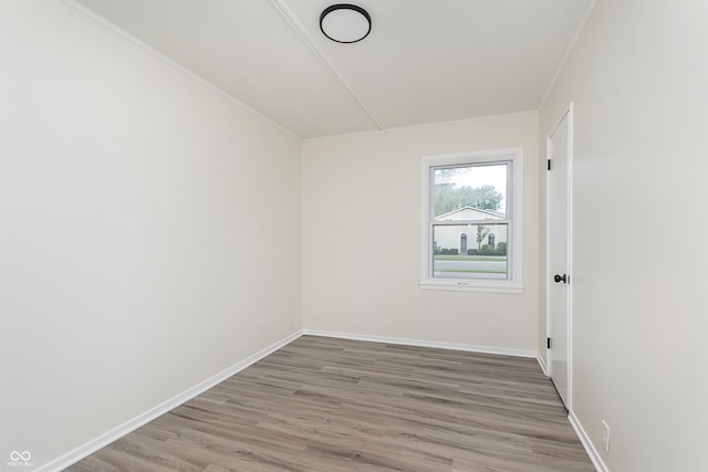 625 E 106th St, Carmel, IN 46280 - spare room featuring light wood-style flooring, baseboards, and crown molding