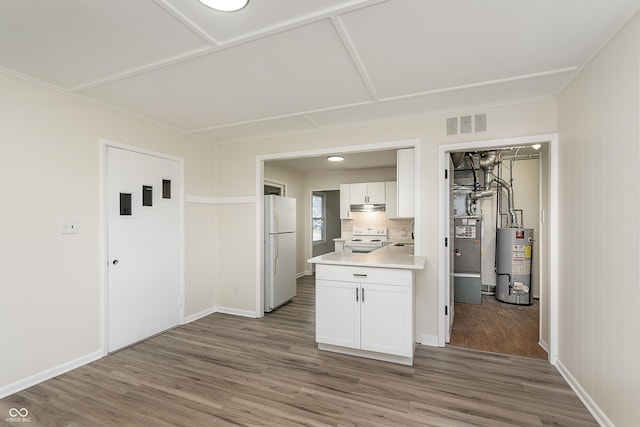 625 E 106th St, Carmel, IN 46280 - kitchen with freestanding refrigerator, electric range oven, water heater, wood finished floors, and light countertops