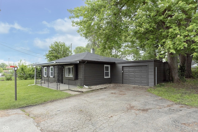 625 E 106th St, Carmel, IN 46280 - view of front facade featuring asphalt driveway, a garage, a front lawn, and a chimney