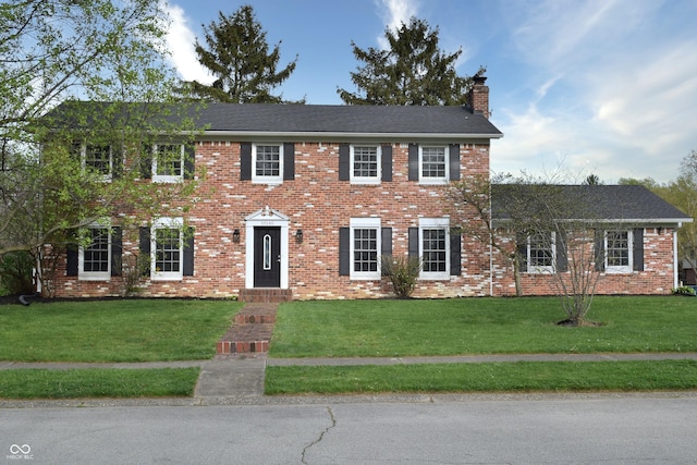 10245 Briar Creek Ln, Carmel, IN 46033 - colonial inspired home with a chimney, a front lawn, and brick siding