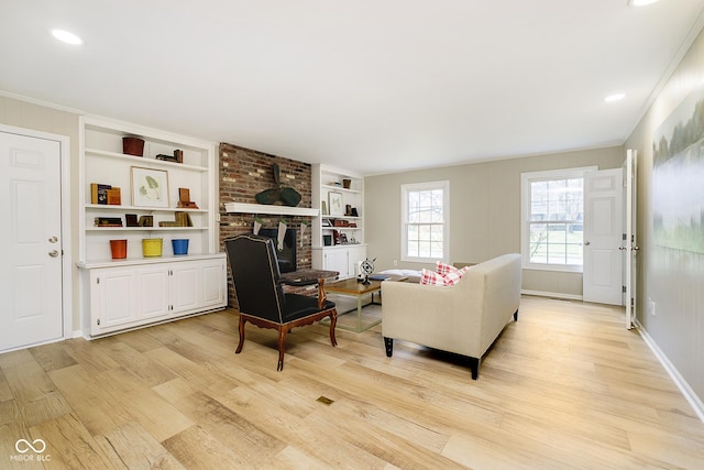 10245 Briar Creek Ln, Carmel, IN 46033 - living area with light wood-style flooring, built in shelves, recessed lighting, crown molding, and baseboards