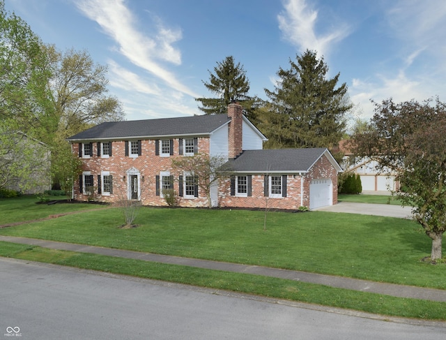 10245 Briar Creek Ln, Carmel, IN 46033 - colonial-style house with a garage, brick siding, concrete driveway, a front yard, and a chimney