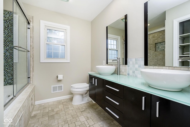 10245 Briar Creek Ln, Carmel, IN 46033 - bathroom with tiled shower, plenty of natural light, double vanity, and toilet