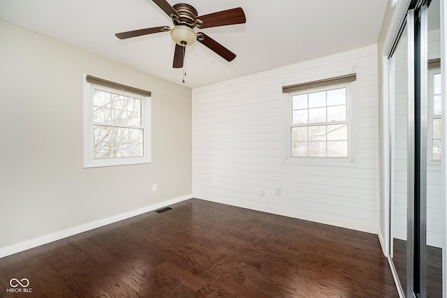 10245 Briar Creek Ln, Carmel, IN 46033 - spare room with plenty of natural light, dark wood finished floors, a ceiling fan, and baseboards