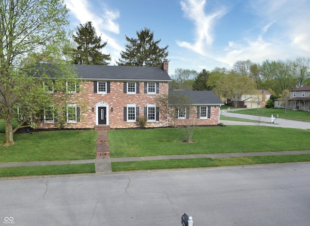10245 Briar Creek Ln, Carmel, IN 46033 - colonial home featuring a chimney, a front lawn, and brick siding