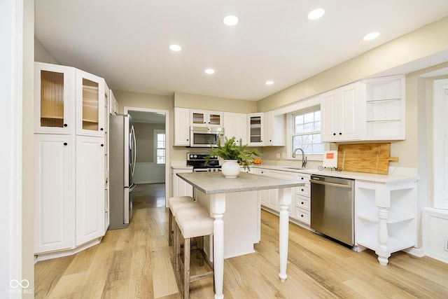 10245 Briar Creek Ln, Carmel, IN 46033 - kitchen with stainless steel appliances, open shelves, a kitchen island, a sink, and recessed lighting