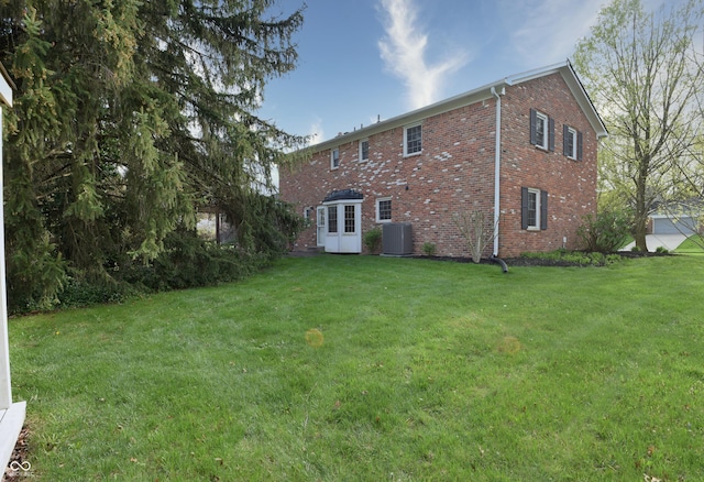 10245 Briar Creek Ln, Carmel, IN 46033 - rear view of property featuring cooling unit, brick siding, and a yard