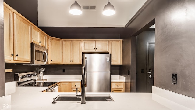 55 S Harding St Unit 308, Indianapolis, IN 46222 - kitchen with light brown cabinets, stainless steel appliances, light countertops, and pendant lighting