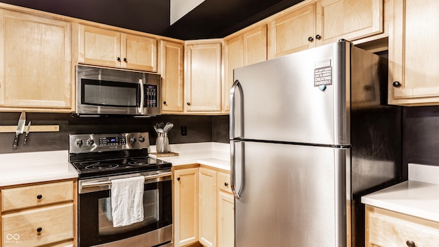 55 S Harding St Unit 308, Indianapolis, IN 46222 - kitchen with appliances with stainless steel finishes, light brown cabinets, and light countertops