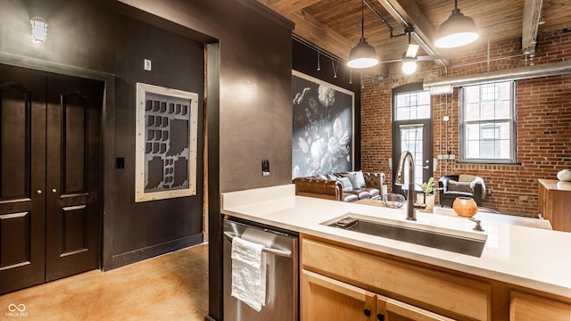 55 S Harding St Unit 308, Indianapolis, IN 46222 - kitchen with a sink, brick wall, dishwasher, light countertops, and wooden ceiling with exposed beams