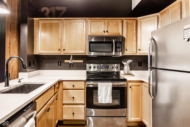 55 S Harding St Unit 308, Indianapolis, IN 46222 - kitchen featuring stainless steel appliances, a sink, and light brown cabinets