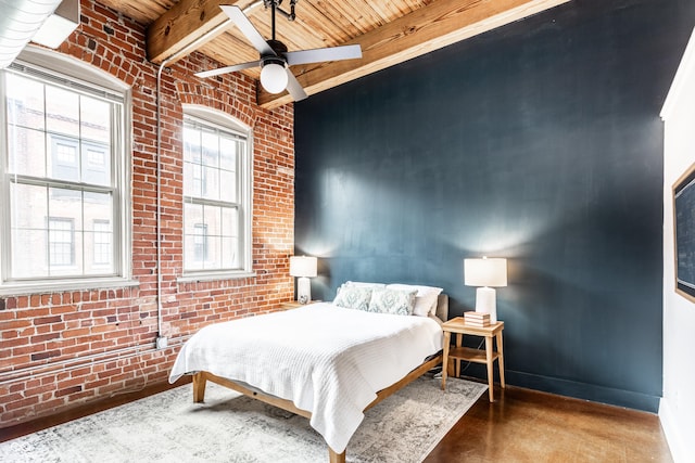 55 S Harding St Unit 308, Indianapolis, IN 46222 - bedroom with wooden ceiling with exposed beams, brick wall, baseboards, ceiling fan, and concrete floors