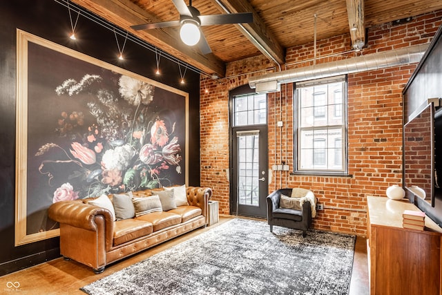 55 S Harding St Unit 308, Indianapolis, IN 46222 - living area with wood ceiling with exposed beams, brick wall, a ceiling fan, and wood finished floors