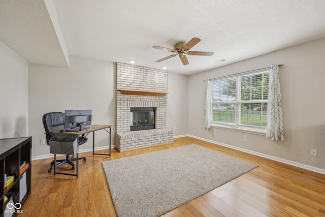 764 Port Dr, Avon, IN 46123 - living room with ceiling fan, a fireplace, baseboards, wood finished floors, and a desk