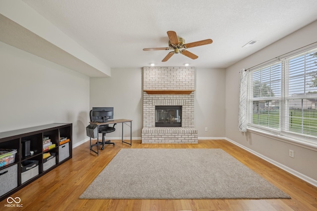 764 Port Dr, Avon, IN 46123 - living room with ceiling fan, a brick fireplace, wood finished floors, and baseboards